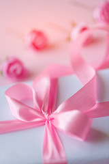 Very beautiful festive pink bow on a white gift box