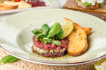 Salam from small pieces of meat in a round form with fresh herbs