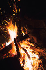 Fire wood brighly burning in furnace. Firewood burn in rural oven. Burning firewood in fireplace closeup. Fire and flames. Close up of burning fire wood in fireplace