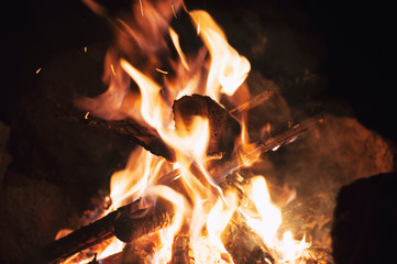 Fire wood brighly burning in furnace. Firewood burn in rural oven. Burning firewood in fireplace closeup. Fire and flames. Close up of burning fire wood in fireplace