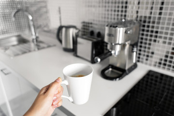 First-person view of a girl preparing delicious aromatic coffee in a coffee machine. A simple way to make coffee