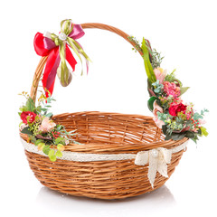 Fototapeta na wymiar A wicker Easter basket in a rustic style on a white background