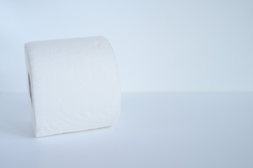 rolled white toilet paper in a white background. space for text