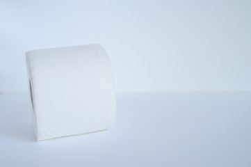 rolled white toilet paper in a white background. space for text