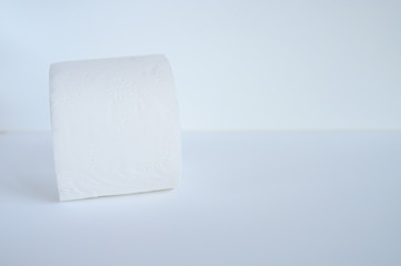 rolled white toilet paper in a white background. space for text
