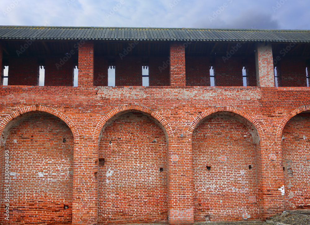 Wall mural Fragment of the old fortress wall. Kolomna Kremlin. Old brickwork. Red brick wall texture