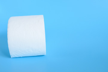 rolled white toilet paper in a blue background. space for text