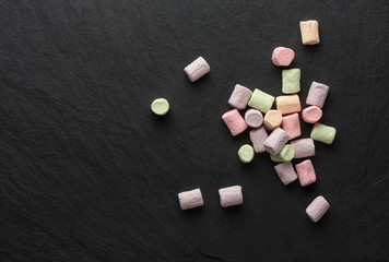 colorful marshmallows on a slate stone board
