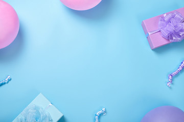Gift boxes and balloons on blue background with copy space.