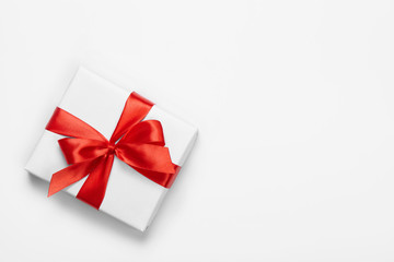 Box with red bow isolated on white background