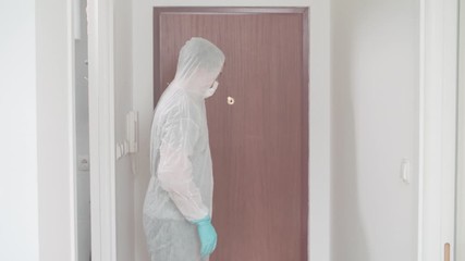 Person wear protective pandemic clothing decontaminate with spray 4K