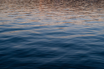 Abstract calm sea water waves pattern at dusk