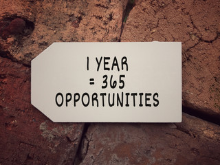 New Year resolution concept. 1 Year = 365 Opportunities written on a small white board.