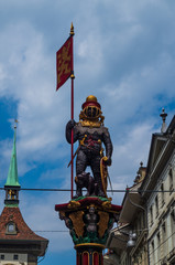Obraz premium Bern City Switzerland street water fountain statue low angle view point sunny overcast day
