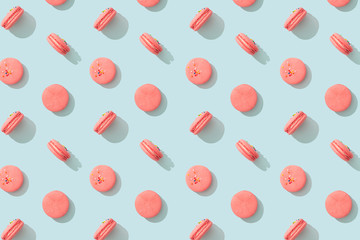 Colorful pattern cakes macaron or macaroon on blue pastel background. French almond cookies dessert, top view. Wrapping paper, poster, greeting card, cover, sale background