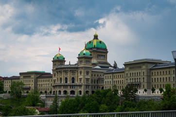 Fototapeta premium Parliament building in Bern city Switzerland overcast day dramatic clouds summer