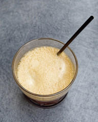 Ice cold espresso coffe glass on grey granite table