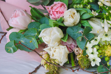 Spring bouquet of multicolored flowers and eucalyptus branches. 