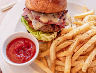 classic burger and french fries with ketchup sauce close up