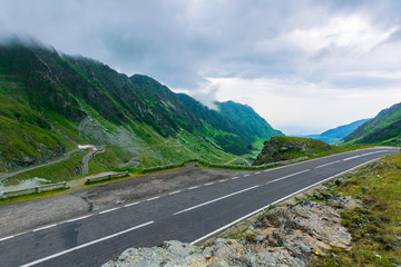 alpine road through mountain valley. epic view of transfagarasan route. popular travel destination. gorgeous landscape of fagaras mountains, romania. cloudy weather
