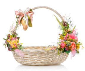 Fototapeta na wymiar Easter basket and with delicate decor on a white background