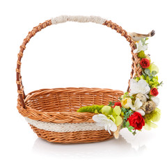 Fototapeta na wymiar Wicker basket with floral decor and ribbons. Isolated