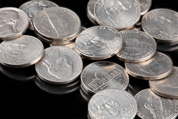 Close up of United States coins, Nickles on black background