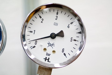 Pressure gauge installed and reading isolated against blurry white background