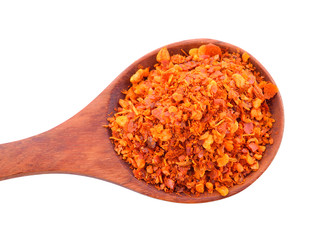 Chili powder in a wooden spoon isolated on a white background