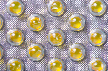 Yellow pills capsule medicine and pharmacy macro background