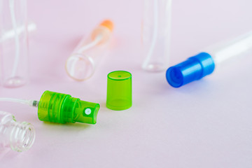 Transparent glass perfume and cosmetic spray bottle on pink background for product packaging concept