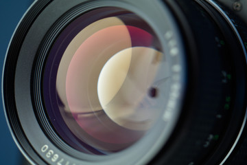 Vintage lens front element close up macro shot with light reflections and visible closed  aperture...
