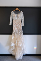 Wedding preparations - beautiful wedding dress on a custom hanger