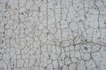 Old road background surface of grey cracked asphalt texture