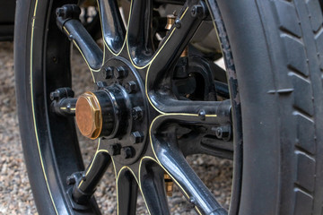 A Wheel of retro car with wooden rim, close up.