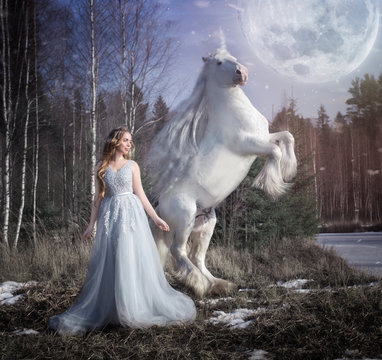 Art photo of a wild white unicorn rearing up and a forest winter virgin