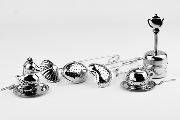 Different kinds of stainless tea strainers isolated on white background.