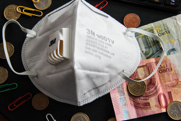 Impact of Coronavirus on Economy Concept Respirator and Paper Bills and Coins Work Themed Background Selective Focus