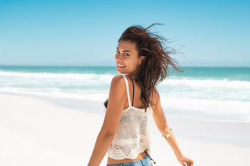 Happy girl running on beach
