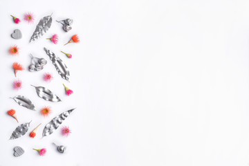 Australian native eucalyptus silver leaves, gum nuts, hearts are decorated with purple & red flowering gum nuts, on a white background. To celebrate Valentines Day, Mothers day, birthday, Anniversary.