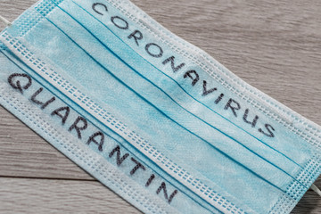 Blue medical face masks with the inscription "Coronavirus", "Quarantine" on it.Pandemic.