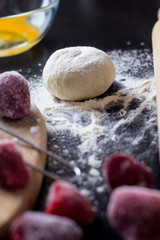 ingredients for baking with strawberries on a black table