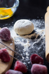 ingredients for baking with strawberries on a black table
