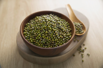Mung bean in a wooden bowl on the wooden table
