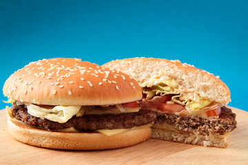 cutaway burger on a wooden board, hamburger, fast food, on a blue background