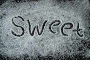 sweet, the test is written with sugar on a black background