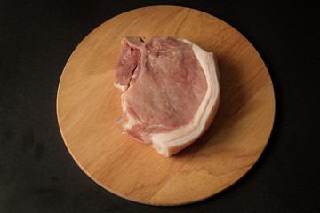 raw meat, pork steak on a wooden board
