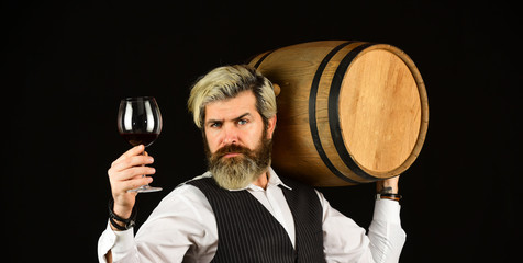 Sommelier at work. Bearded businessman in elegant suit with barrel. Sommelier tastes expensive...