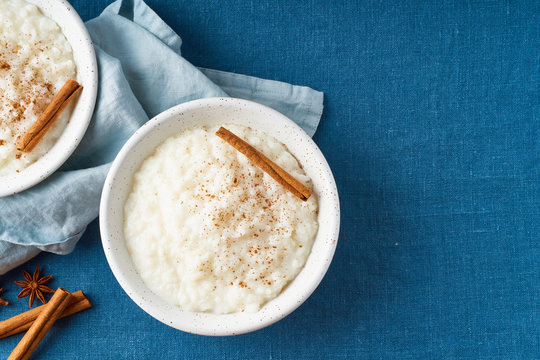 Rice pudding. French milk rice dessert. Dark background. Top view, copy space