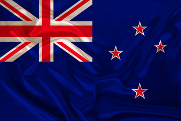 photo of the New Zealand state national flag on a luxurious texture of satin, silk with waves, folds and highlights, close-up, copy space, illustration